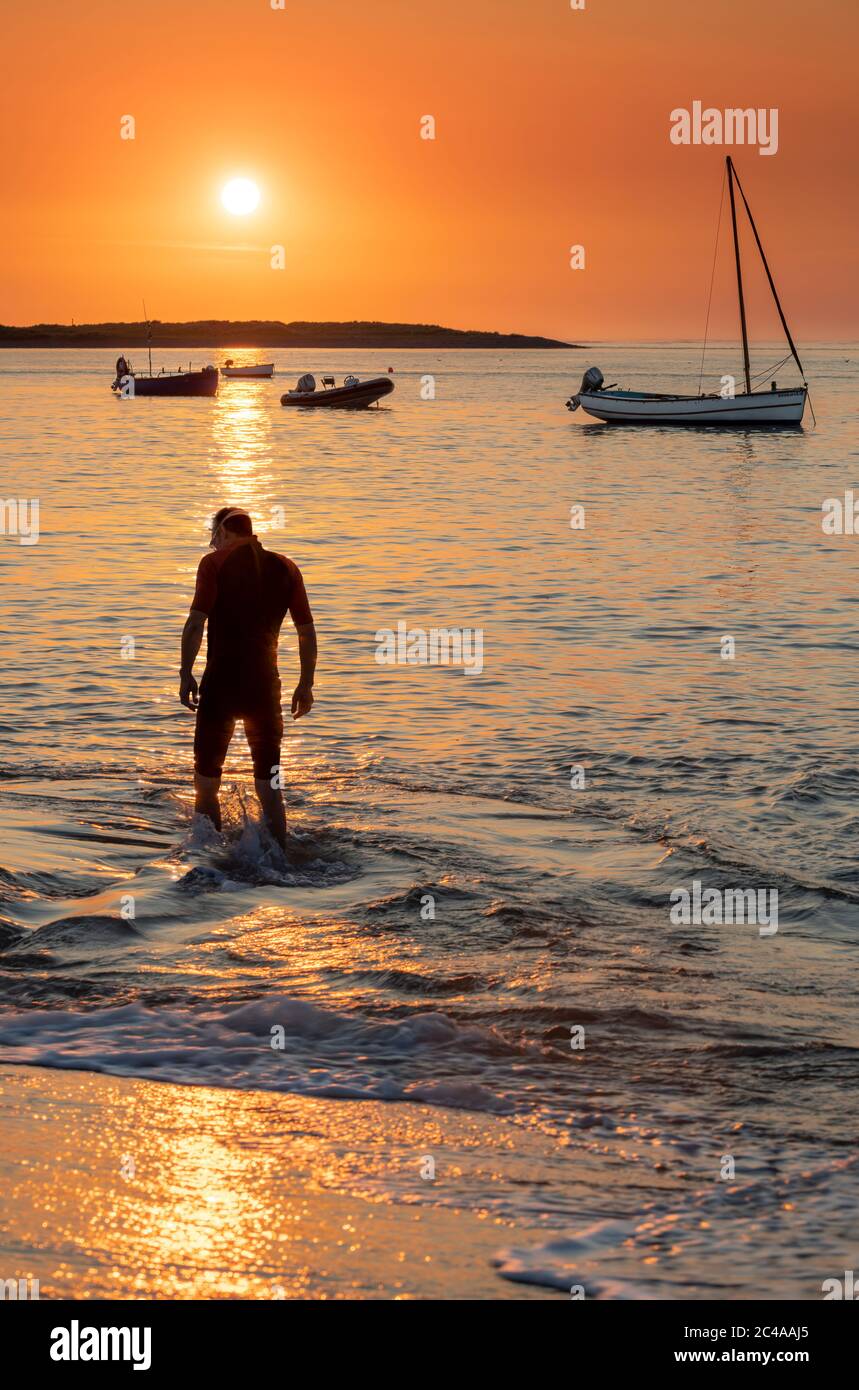 With municipal swimming pools still closed due to the Covid-19 pandemic, after a hot summer's day, an 'Open Water' Swimmer enters the River Torridge f Stock Photo