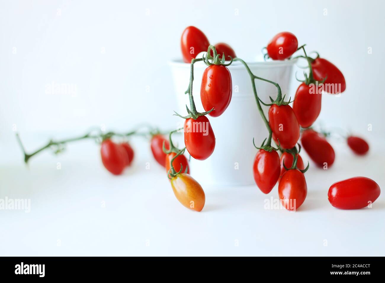 fresh red tomatoes in a basket on a white background Stock Photo - Alamy
