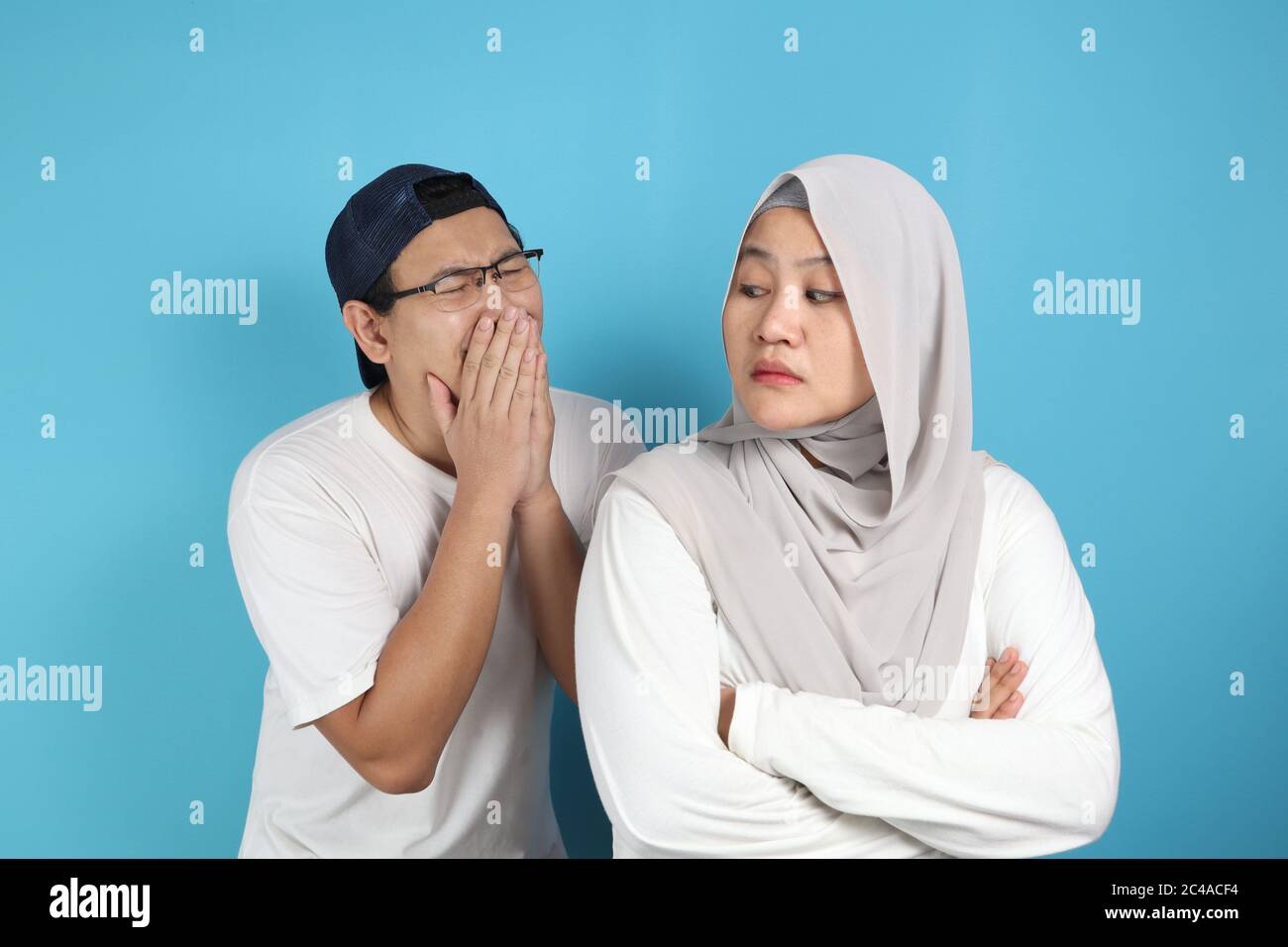 Muslim couple having conflict, husband trying to resolve, persuade and apologize to his wife after fight Stock Photo