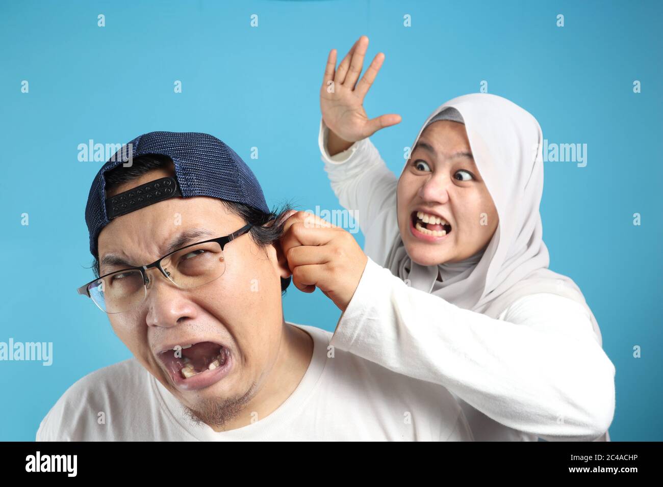 Portrait of funny Asian muslim couple having conflict, wife and husband fight, violence in family, husband afraid to his wife concept Stock Photo - Alamy Portrait of funny Asian muslim couple having conflict, wife and husband fight, violence in family, husband afraid to his wife concept Stock Photo - Alamy