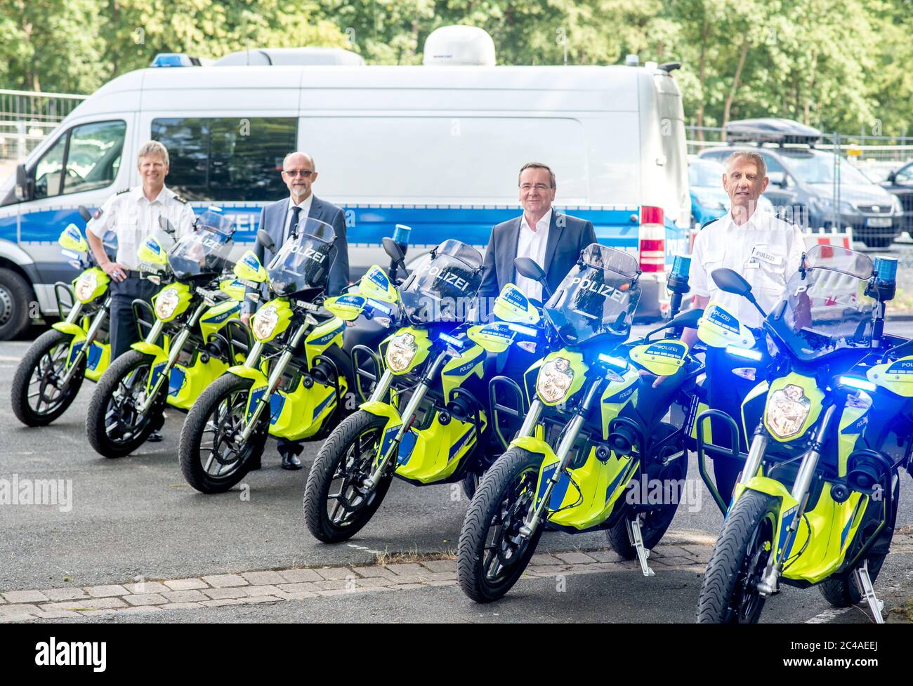 25 June 2020, Lower Saxony, Hanover: Jens Künnmann (l-r), Head of the Police Inspectorate for Special Services, Volker Kluwe, Police President of the Hanover Police Department, Boris Pistorius (SPD), Minister of the Interior in Lower Saxony, and Detlef Hoffmann, Head of the Hanover Police Inspectorate, stand between new police motorcycles. The Ministry of the Interior and the Hanover Police Headquarters have presented the results of an optimisation analysis for the police's presence and intervention capability. Photo: Hauke-Christian Dittrich/dpa Stock Photo