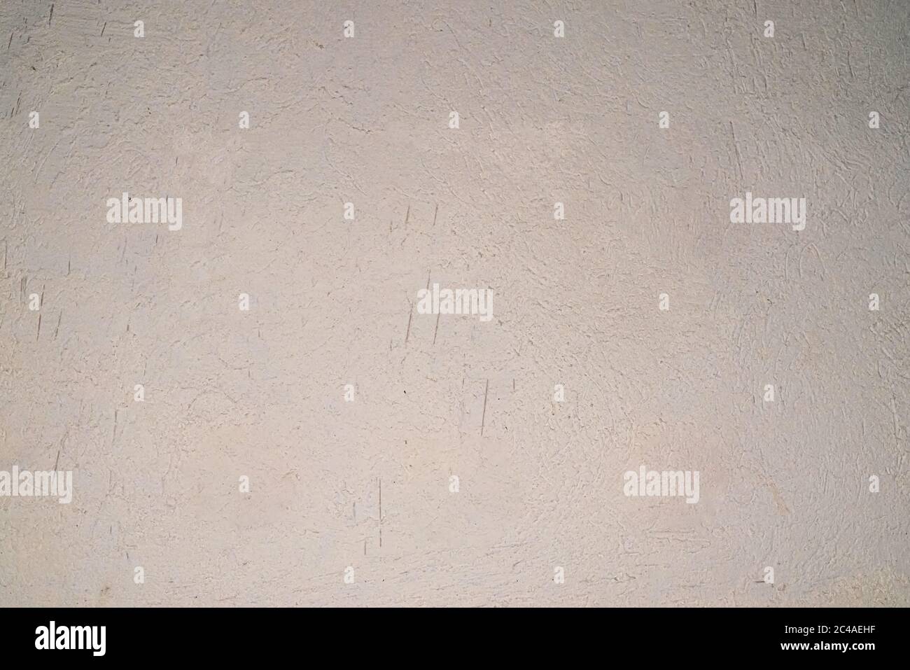 an aged white rough texturized wall. Copy space. Stock Photo