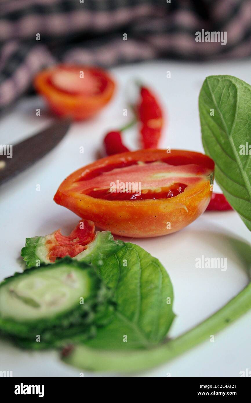 Red chili and tomato sliced onn white surface Stock Photo Alamy