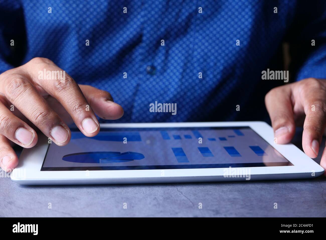 man's hand working on digital tablet at office desk, using self created ...