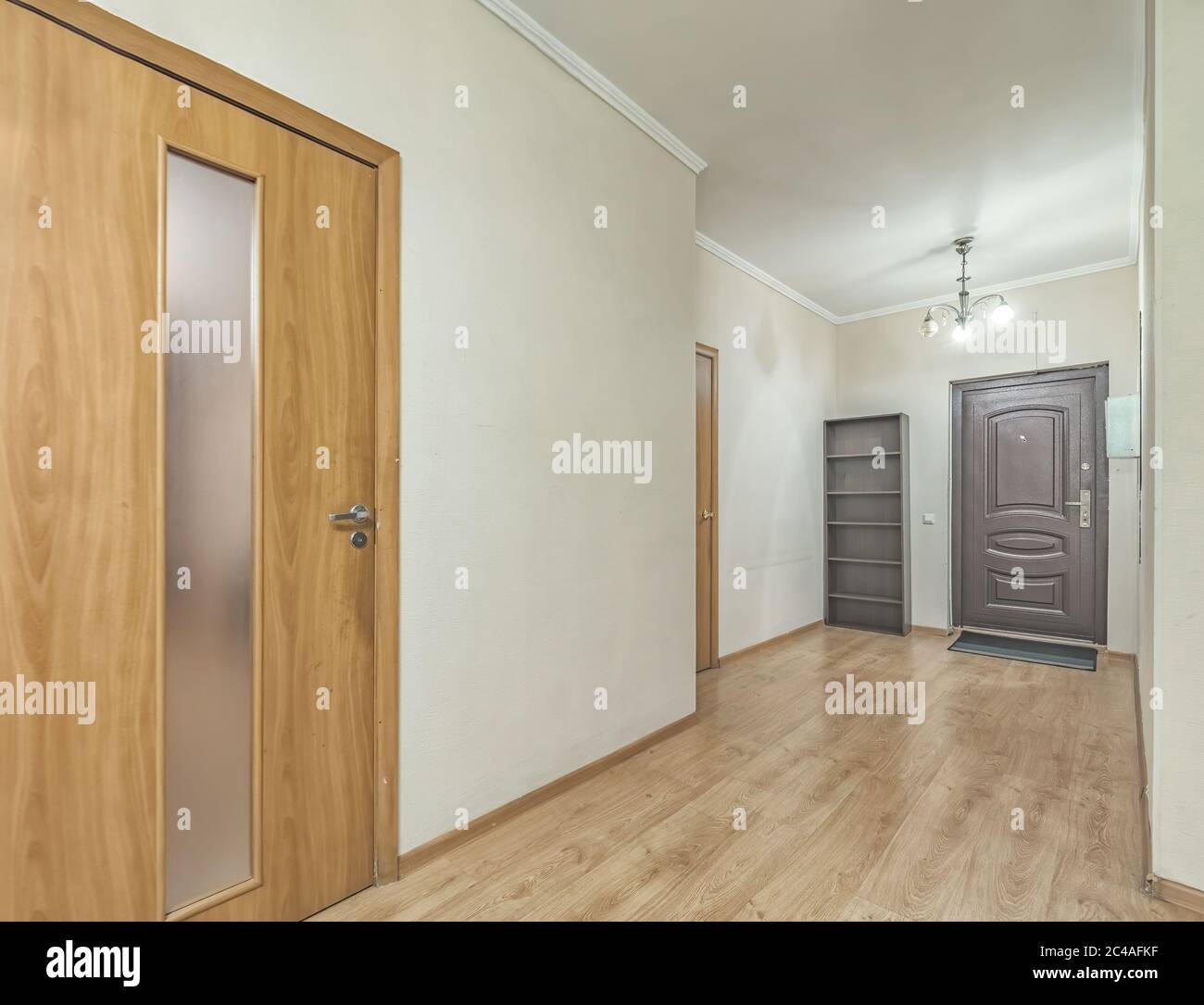Empty residential house entrance with closed wooden doors tiny hallway Stock Photo