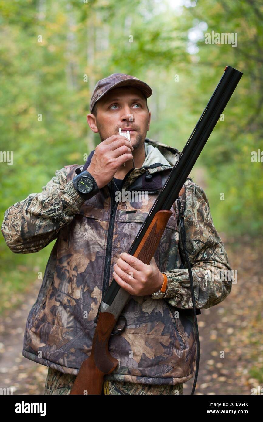 Hunter with a grouse call and gun Stock Photo