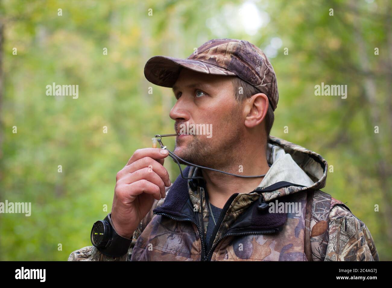 hunter with a grouse call Stock Photo