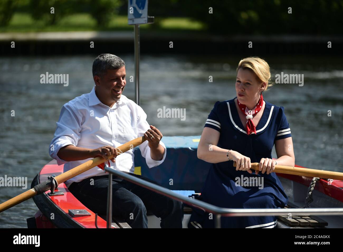 Berlin, Germany. 25th June, 2020. Franziska Giffey (r), Federal Minister for Family Affairs, and Raed Saleh (both SPD), SPD parliamentary party leader in Berlin, cross the Müggelsee on a rowing boat ferry to visit the professional fishermen in the Müggelsee fishery. Giffey and Saleh, who plan to run for the SPD presidency in Berlin together at the SPD party conference in the fall, will inform themselves about the economic situation at the time of the corona pandemic. Credit: Sven Braun/dpa/Alamy Live News Stock Photo