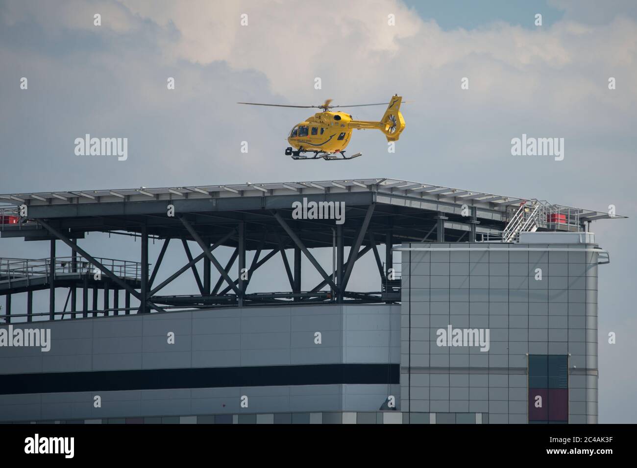 Glasgow, Scotland, UK. 25th June, 2020. Picture: Queen Elizabeth University Hospital (QEUH) helipad which is situated on the south west of the main building. Seen is the Scottish Air Ambulance Service transferring a patient. Credit: Colin Fisher/Alamy Live News Stock Photo