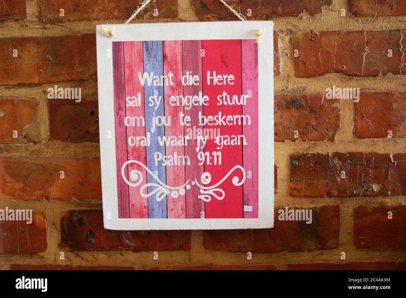 The Crags, South Africa: Wall decoration with the bible psalm 91:11 in Afrikaans language. In a small dinner in the countryside. Garden Route. Africa. Stock Photo