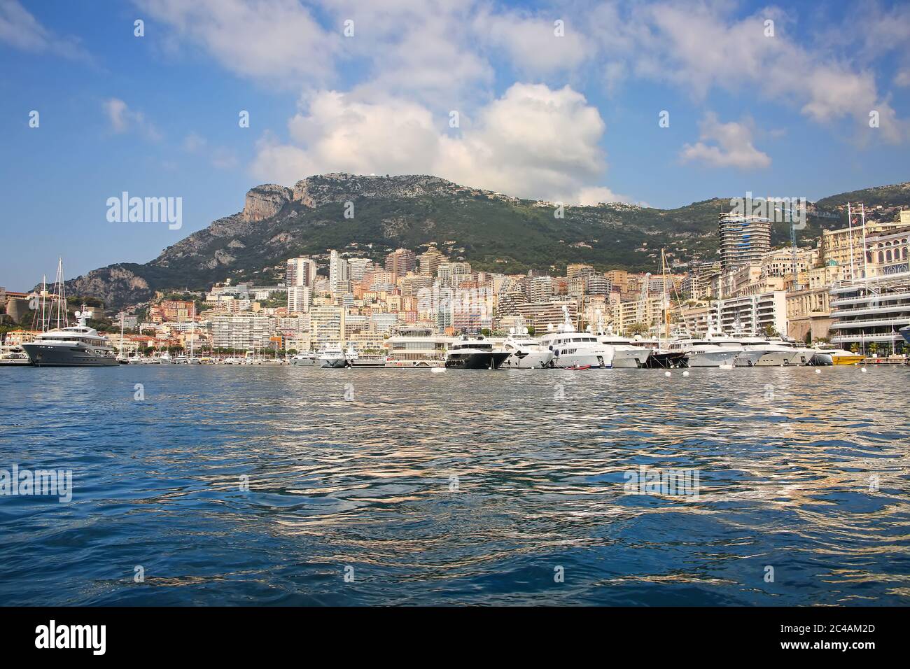 View from the Mediterranean sea of the Principality of Monaco, and Monte Carlo, with dense skyscrapers , marina, yachts, palace & casino. Stock Photo