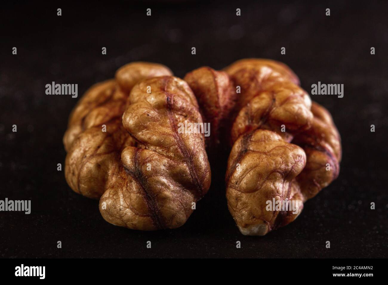 Walnut peeled close-up on dark background Stock Photo
