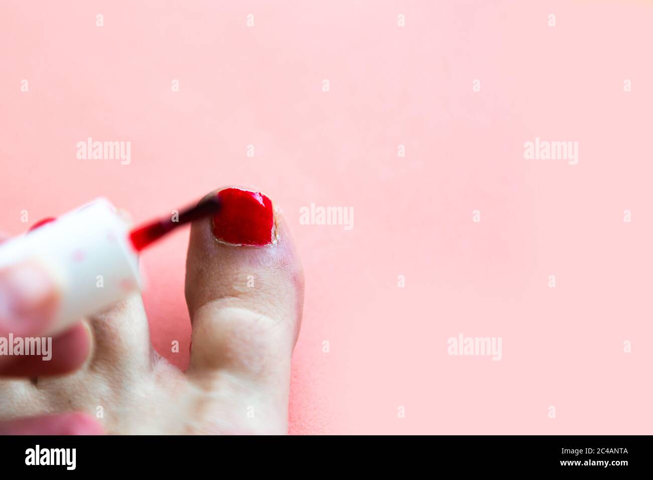 Woman paints her toenails red polish, view from above Stock Photo Alamy