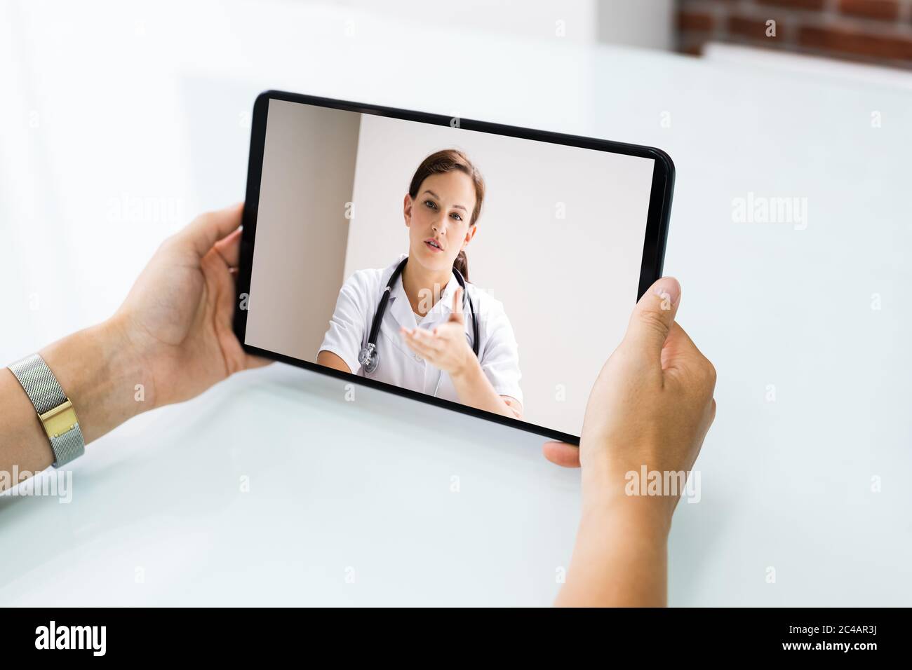 Video Conference Chat With Doctor On Tablet Stock Photo