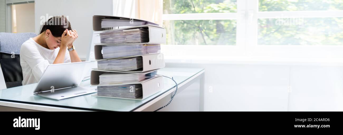 Frustrated Workaholic Woman At Computer Desk. Professional Businesswoman Stock Photo