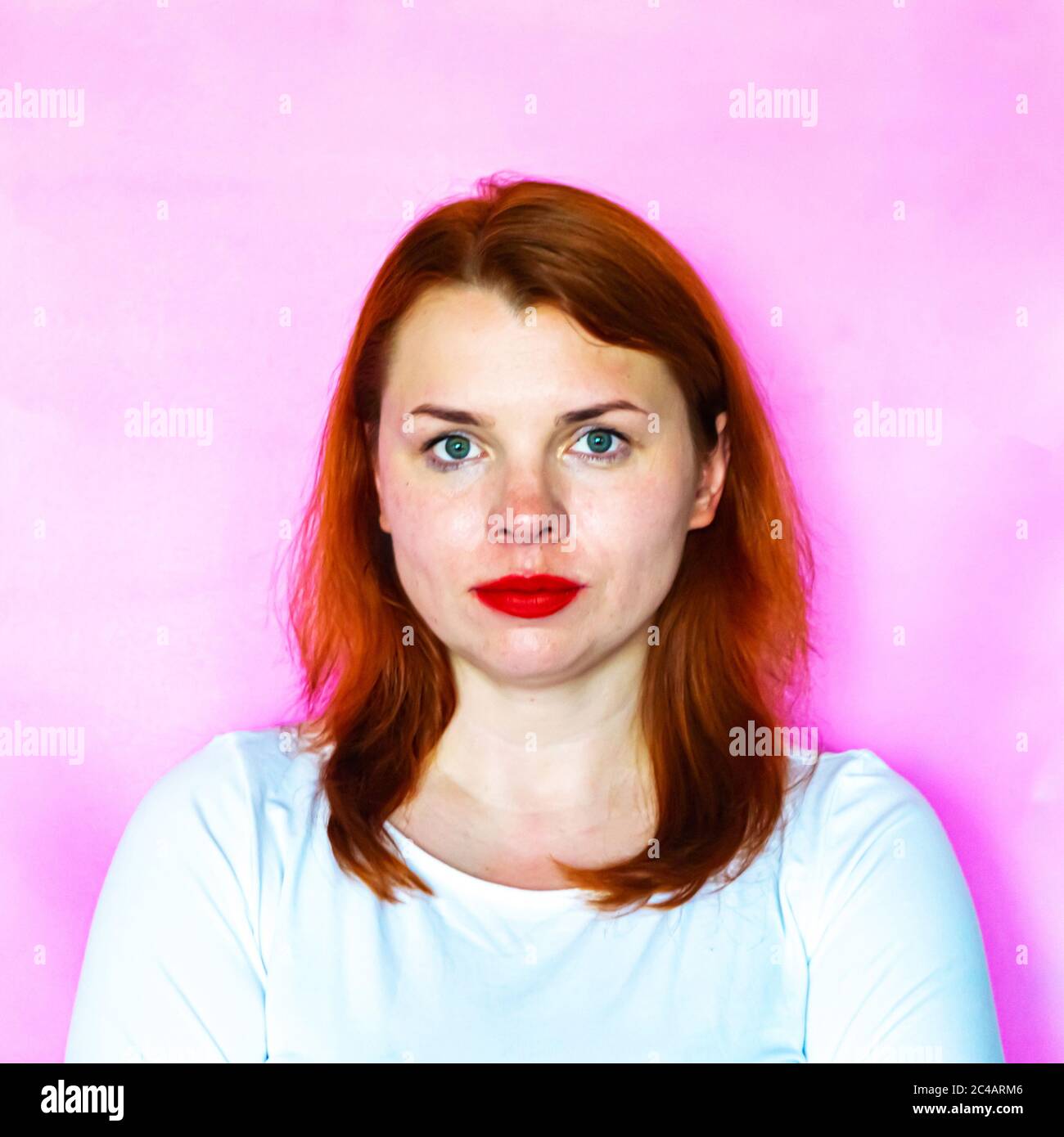 Portrait of a beautiful redhead girl on pink background Stock Photo - Alamy