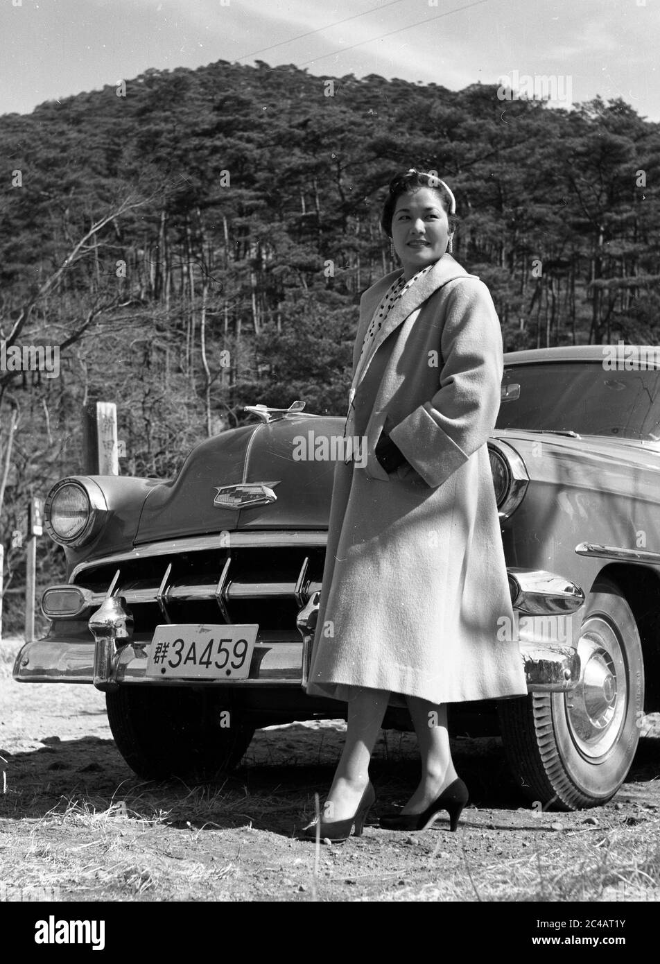 Fashion model in front of car 1950's Street Scene, Japan. 1954 Chevrolet Bel Air 2-door Hardtop Stock Photo