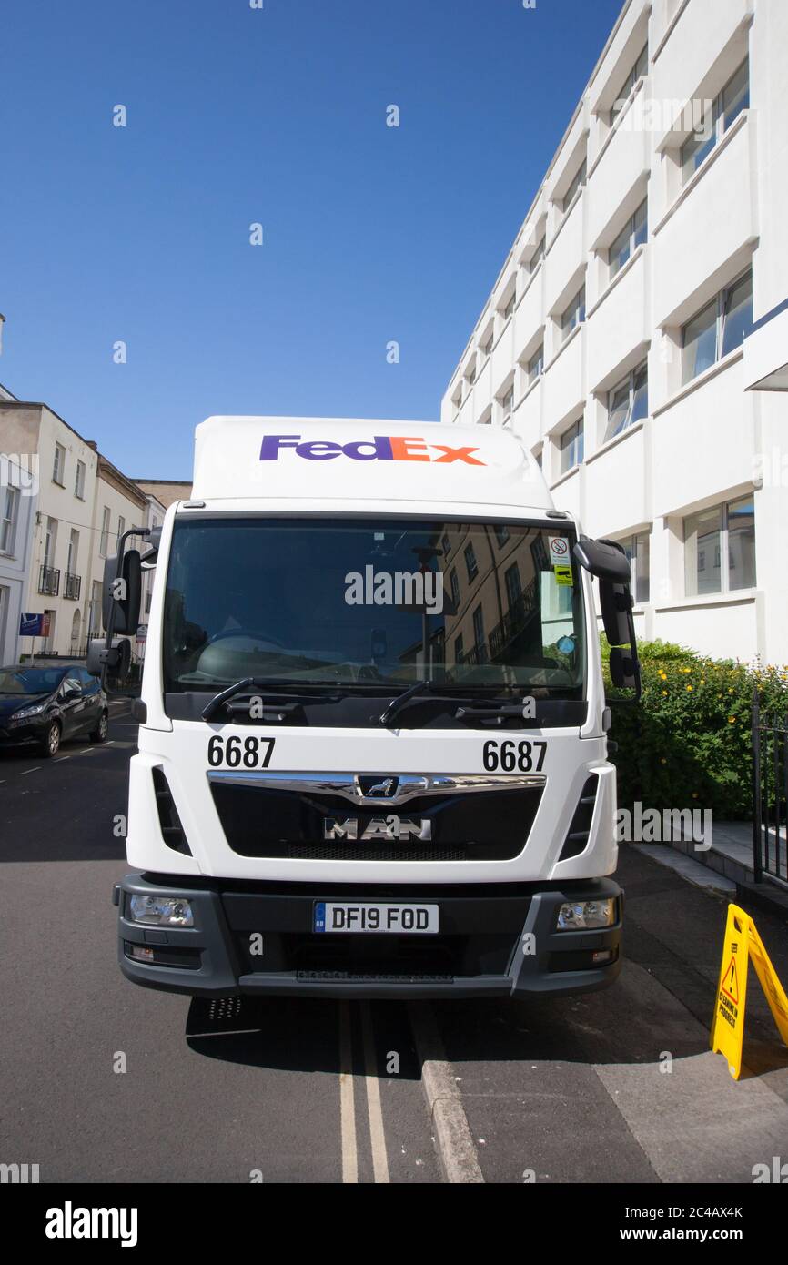 A FedEx lorry stops in Cheltenham to deliver a package Stock Photo