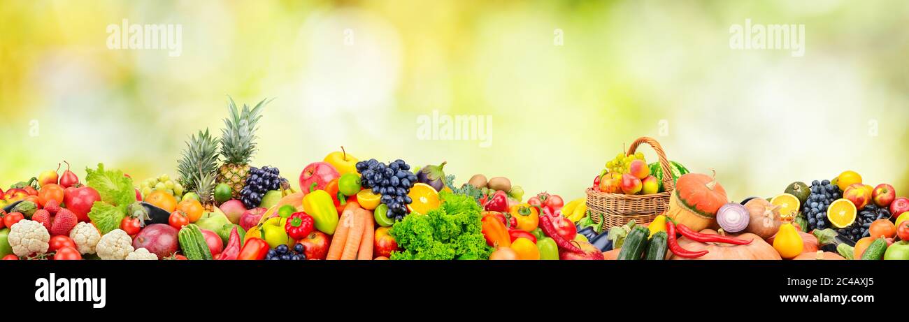 Wide panoramic photo fruits, vegetables, berries for your layout on green blurred background Stock Photo
