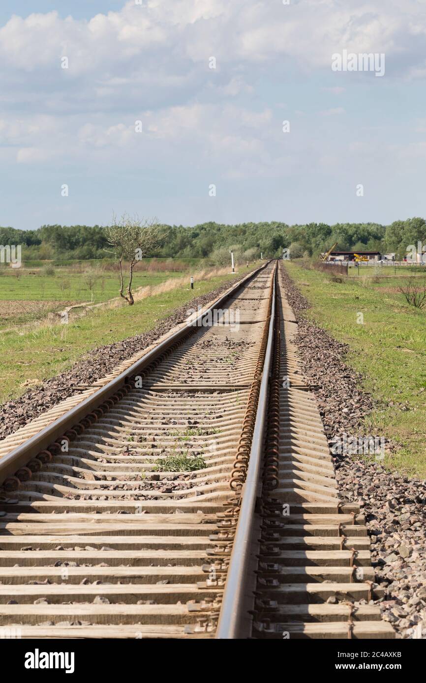 Railway track goes into the distance and up. Vertical orientation. Stock Photo