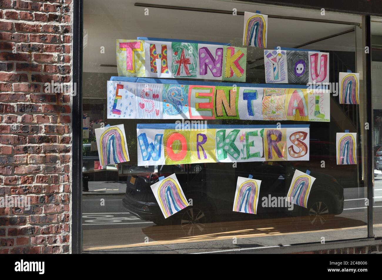 Colorful hand-drawn letters on a glass window spelling out 'Thank you essential workers', May 31, 2020, in New York. Stock Photo