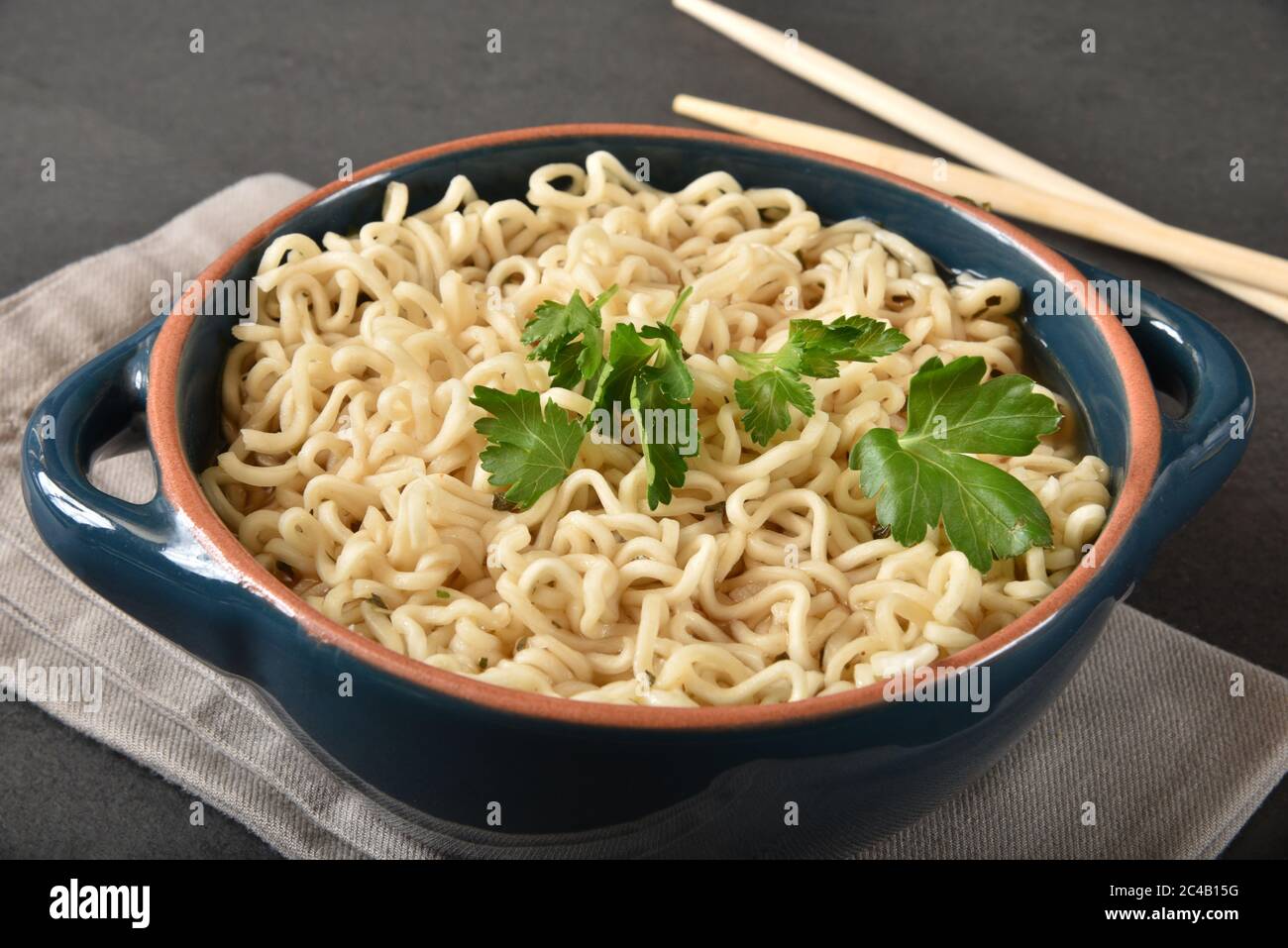 A bowl of raman noodles with Italian parsley and chop sticks Stock ...