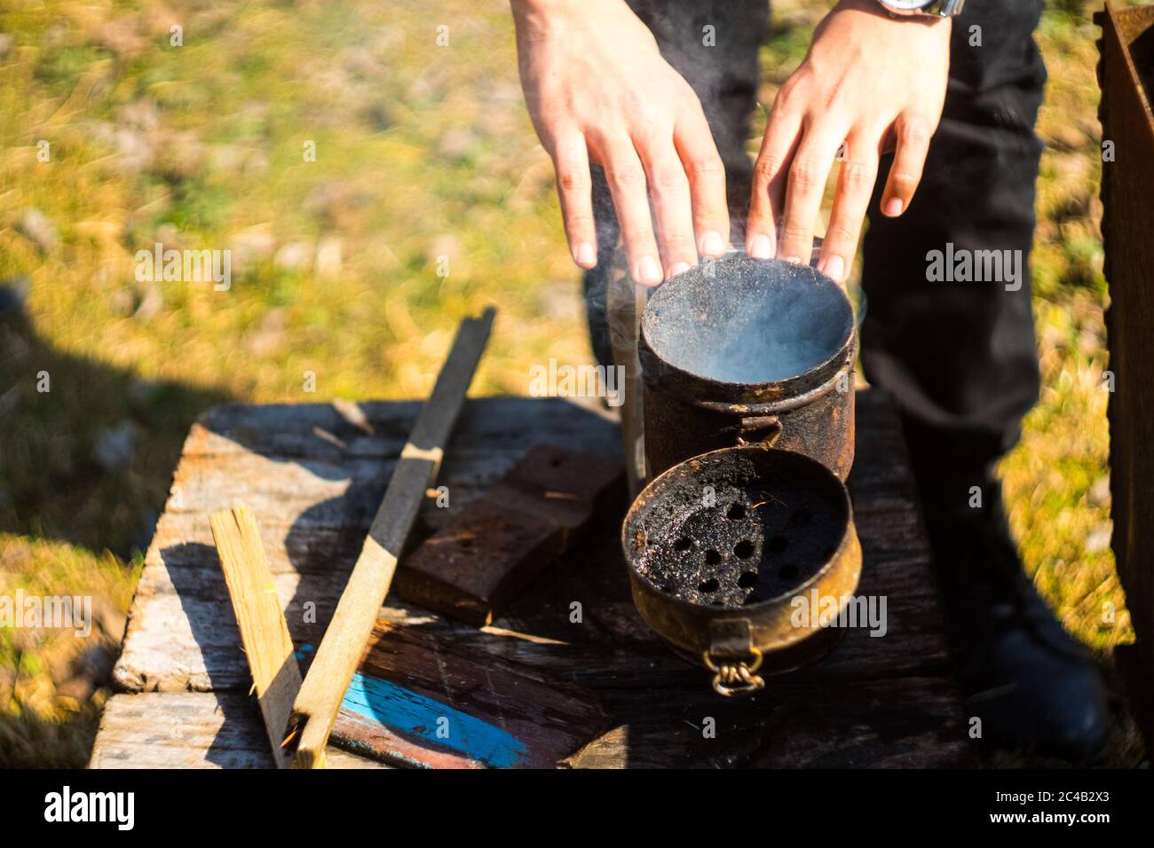 A beekeeper preparing smoker for bee control Stock Photo