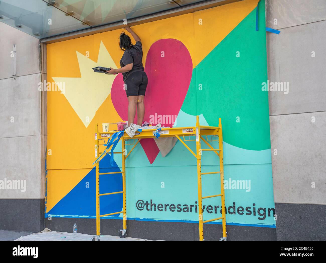 New York, United States. 24th June, 2020. Theresa Rivera design artists paint mural ‘Love NYC