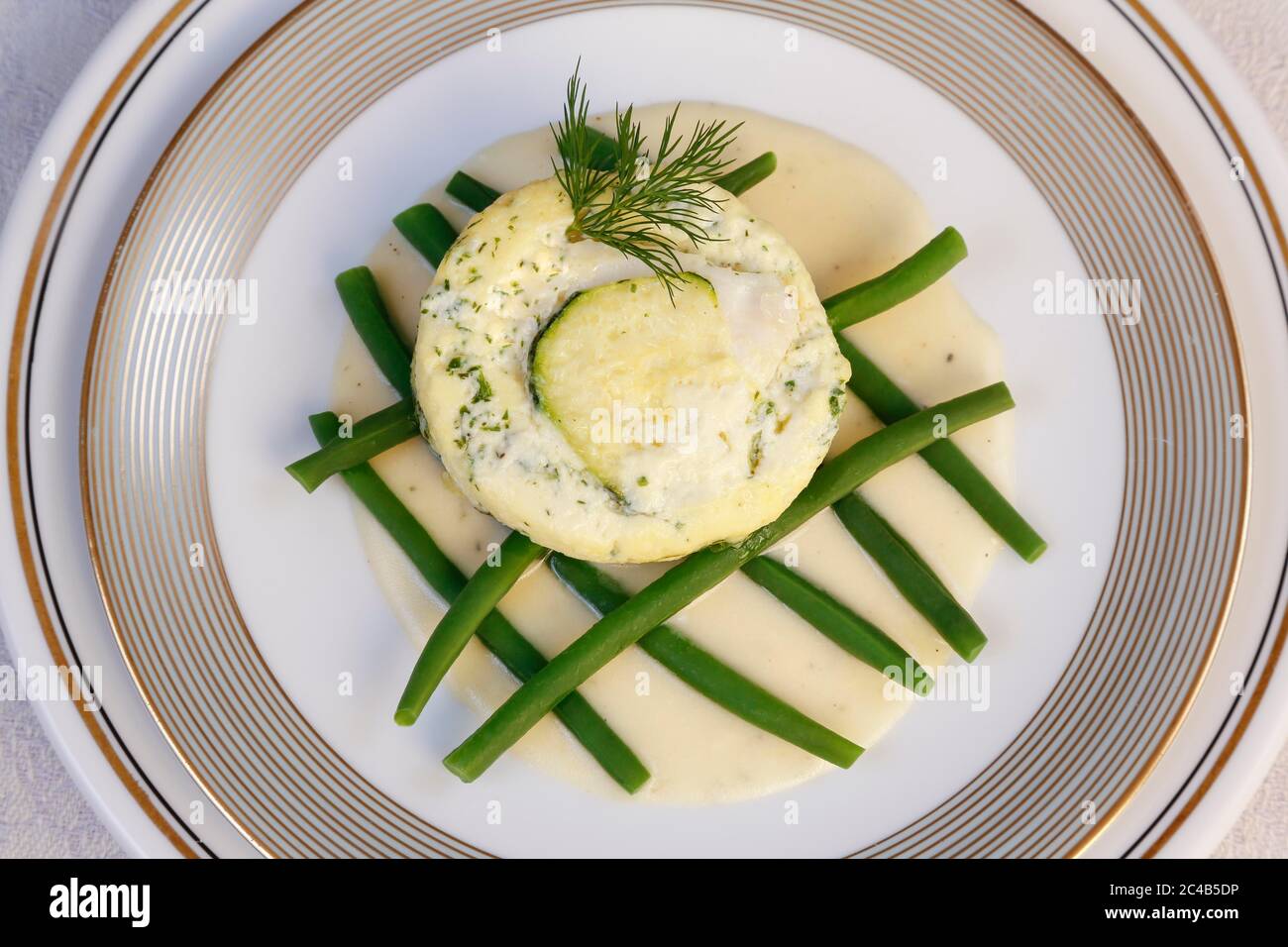 Swabian cuisine, Ofenschlupfer with pike-perch, green beans with sauce arranged on plates, dill, Germany Stock Photo