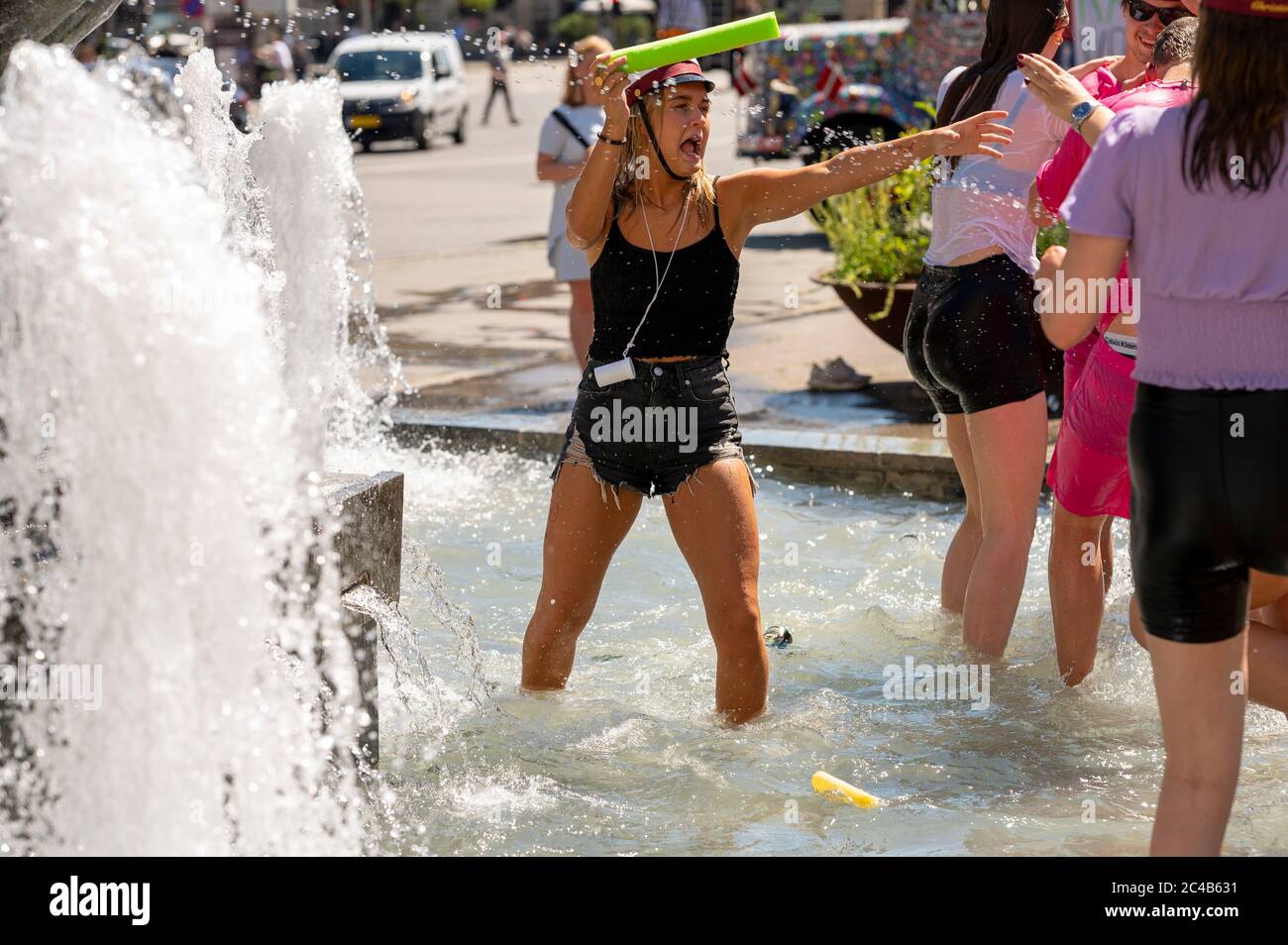 High school students playing in the fountain celebrating finishing high school in Arhus, Denmark on 25 June 2020 Stock Photo