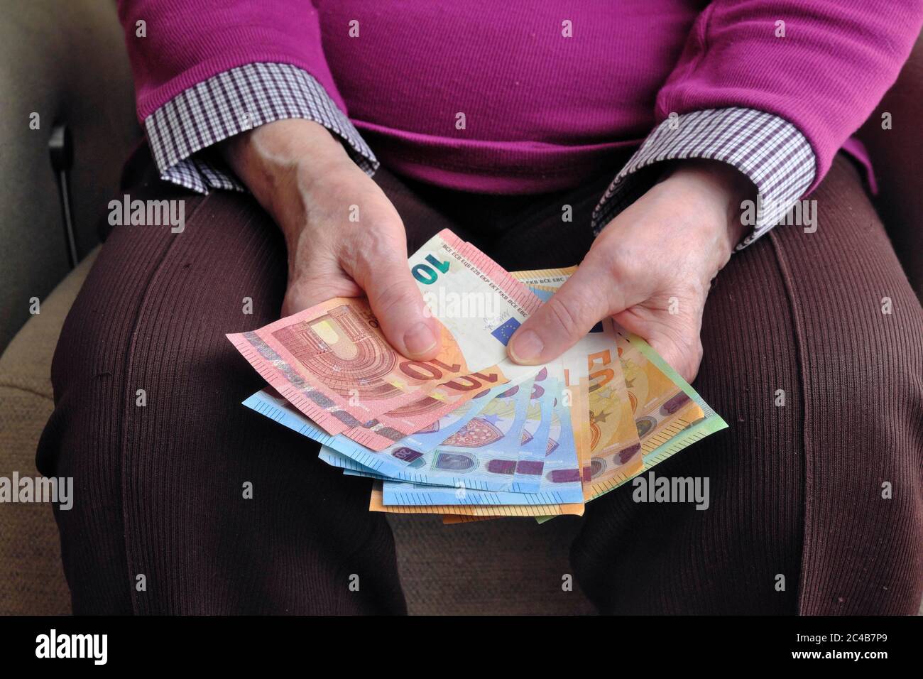 Hand of a senior citizen with euro notes, counting her money, Munich, Bavaria, Germany Stock Photo