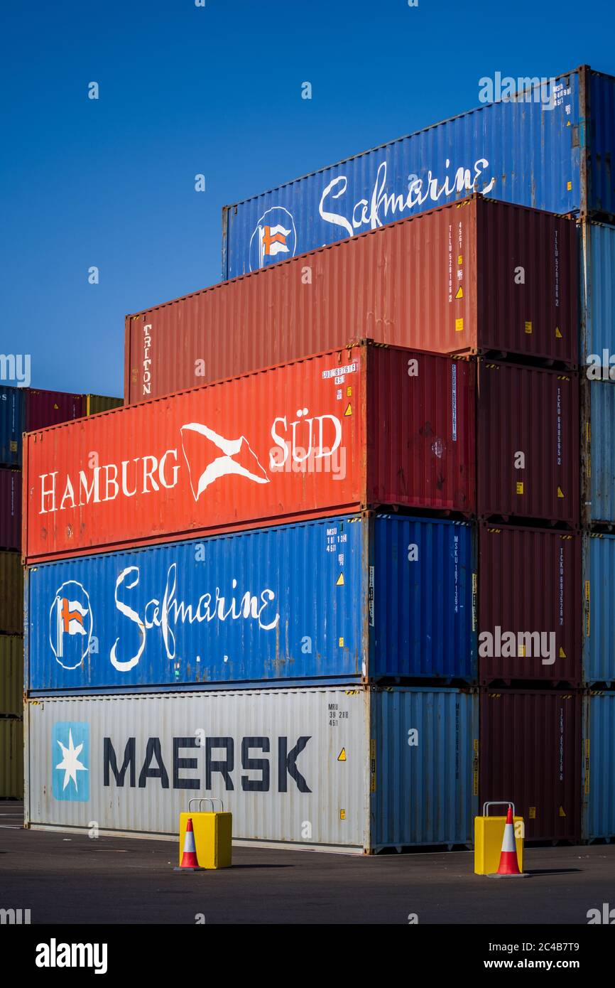 Shipping Containers - Hamburg Sud, Safmarine and Maersk intermodal shipping containers stacked at a container port dock. Stock Photo