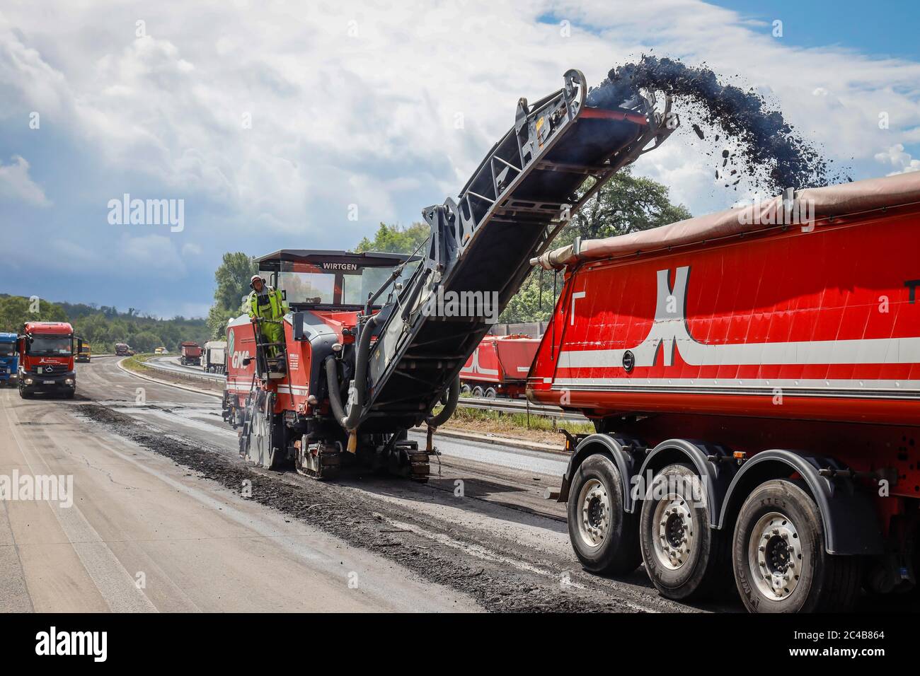 Road construction, cold milling machine removes old asphalt layer and