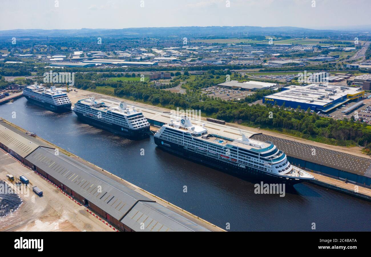 Glasgow, Scotland, UK. 25 June, 2020. Aerial view of the cruise ships Azamara Journey (nearest) and sister vessels, Azamara Quest (middle) and the Azamara Pursuit at King George V Docks on the Clyde in Glasgow. The ships are currently out of service due to the suspension of the cruise industry because of Covid-19 pandemic.  Iain Masterton/Alamy Live News Stock Photo