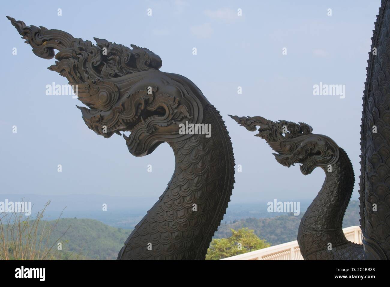 Wat Pa Phu Kon Thailand Blue temple Great Wihan Curved necks of two serpent monsters against blue sky Landsacepe format Stock Photo