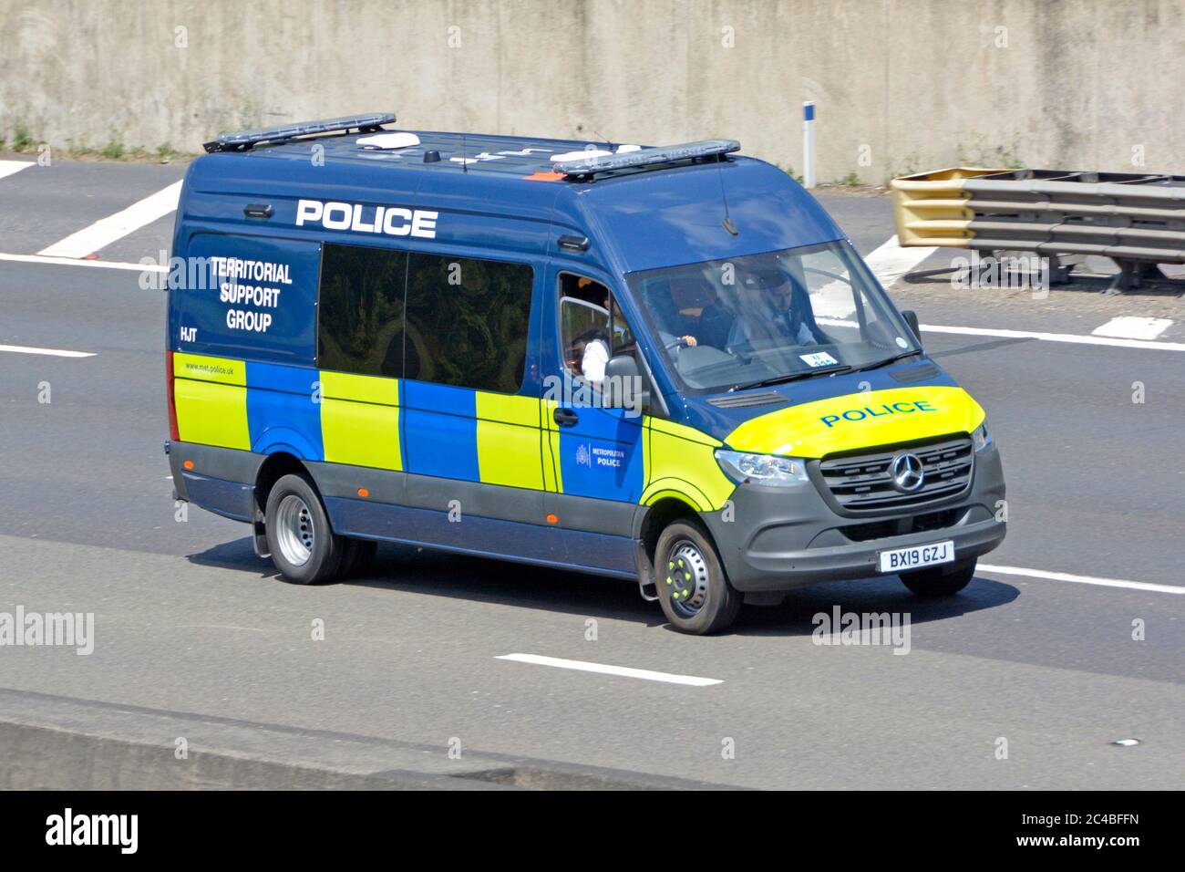 Met police force London Metropolitan Police Territorial Support Group Mercedes Benz people carrier van & driver in uniform M25 motorway England UK Stock Photo