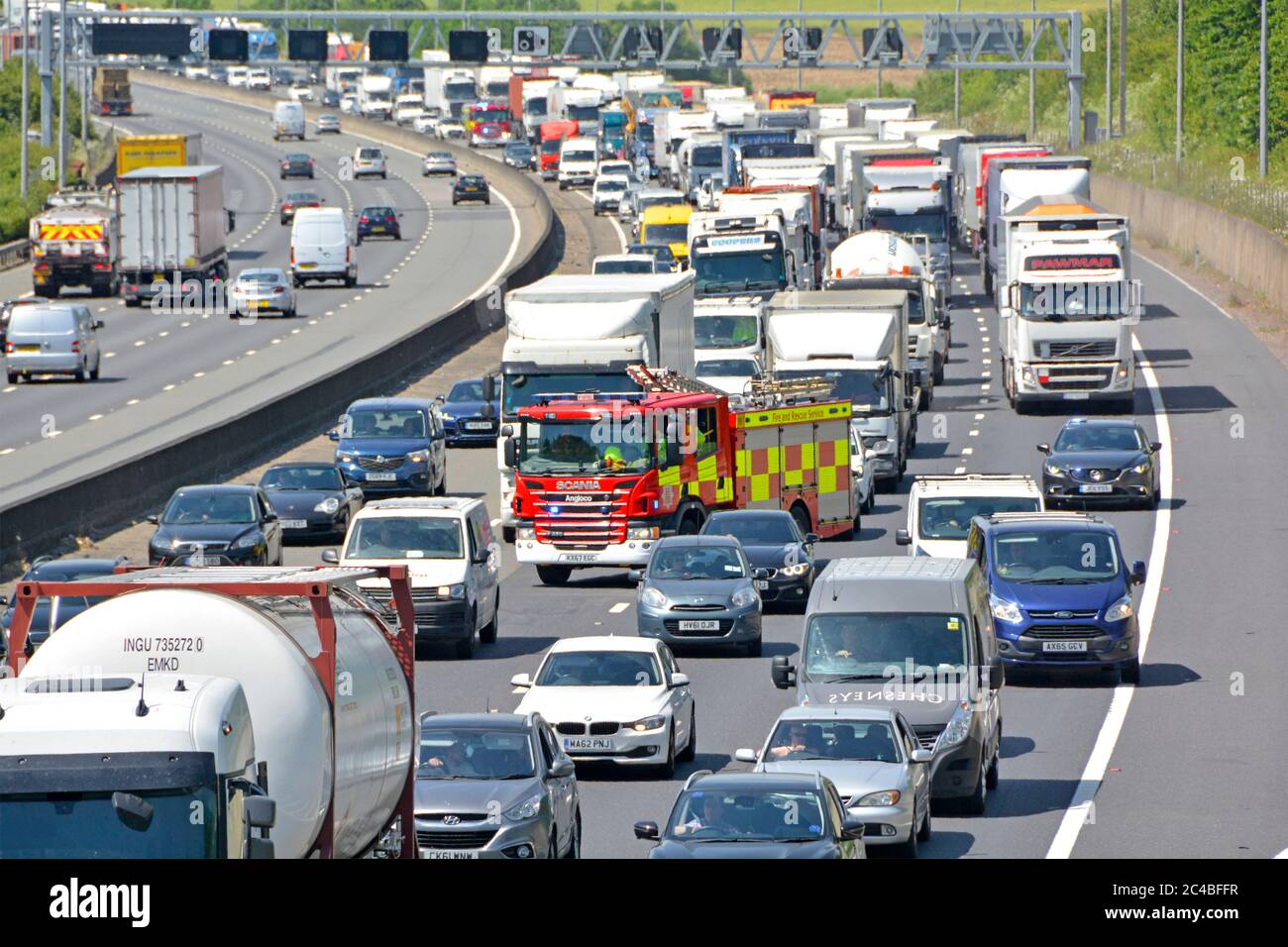 Traffic jam motorway gridlock & fire engines on emergency services call to reach scene of accident as cars & vans try to move away on m25 UK see note Stock Photo