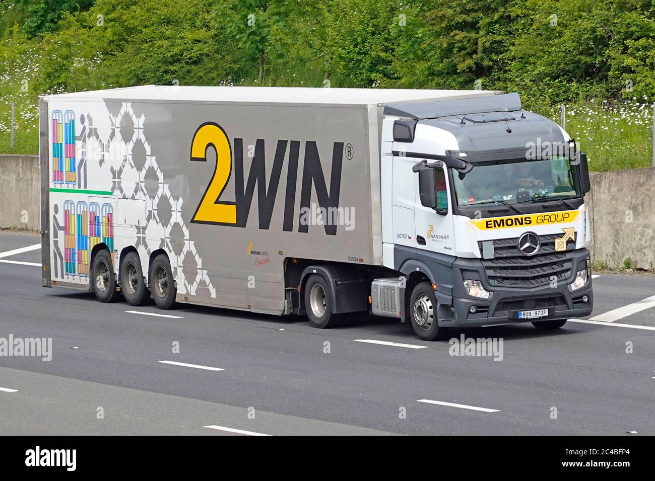 Emons Cargo Dutch transport business  use 2WIN double deck articulated trailer for non stackable goods with left hand drive lorry truck on UK motorway Stock Photo