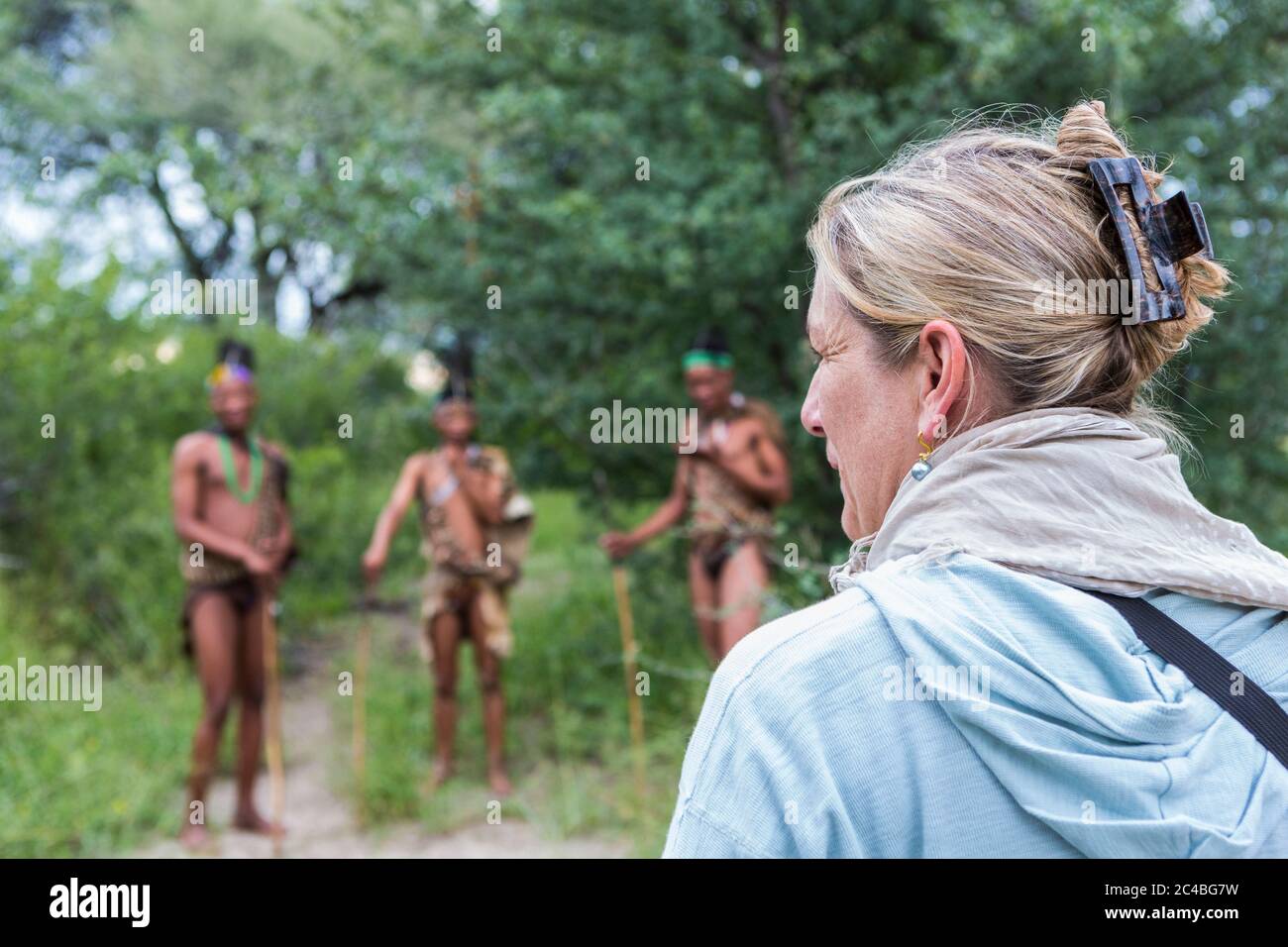Tourists on a walking trail with members of the San people, bushmen. Stock Photo