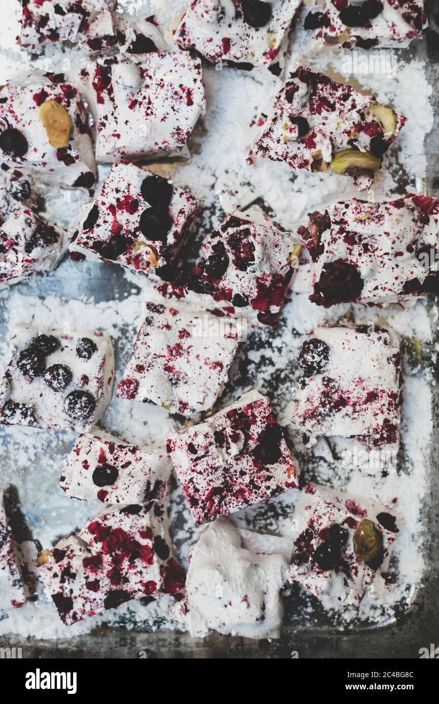 Christmas baking, close up of slices of a traybake with berrie and nuts. Stock Photo