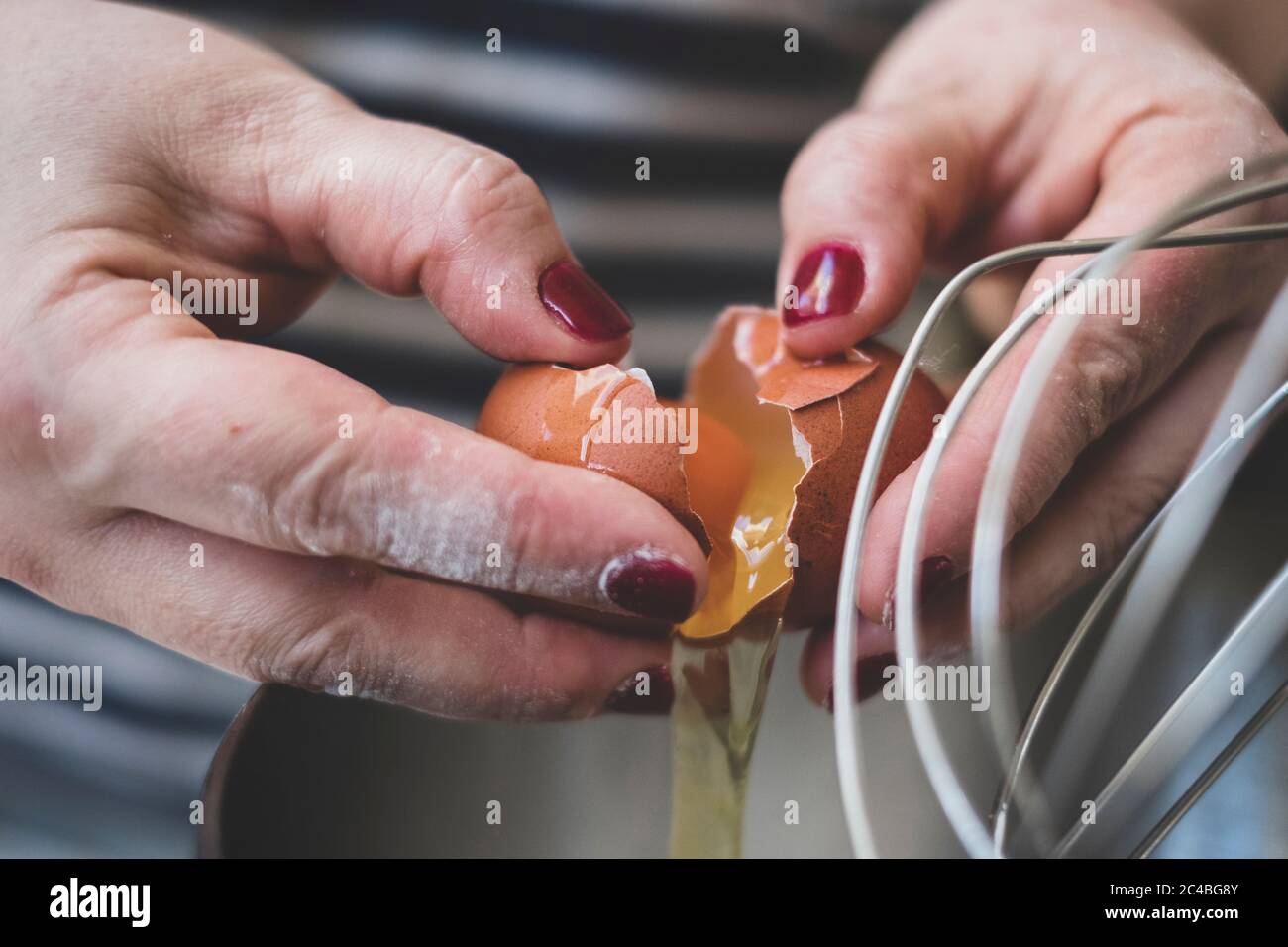 Cook separating eggs for baking Stock Photo Alamy