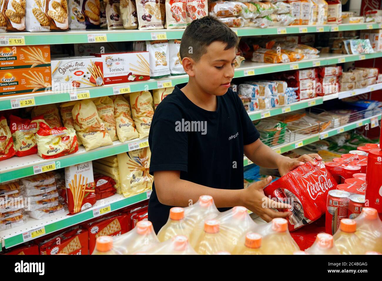 Teenager buying soft drinks in a supermarket in salento, italy Stock Photo