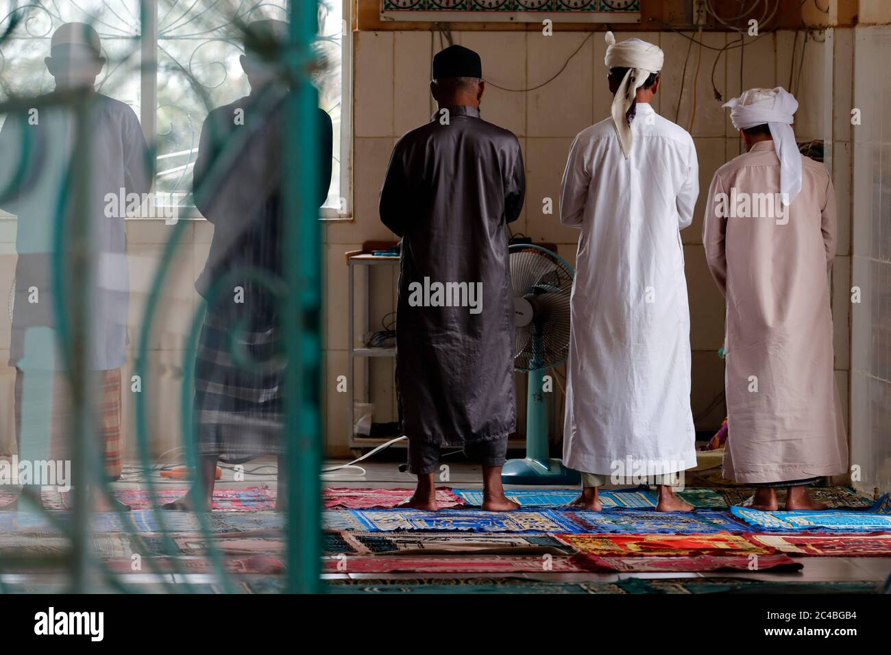 Muslim men praying in mosque Stock Photo