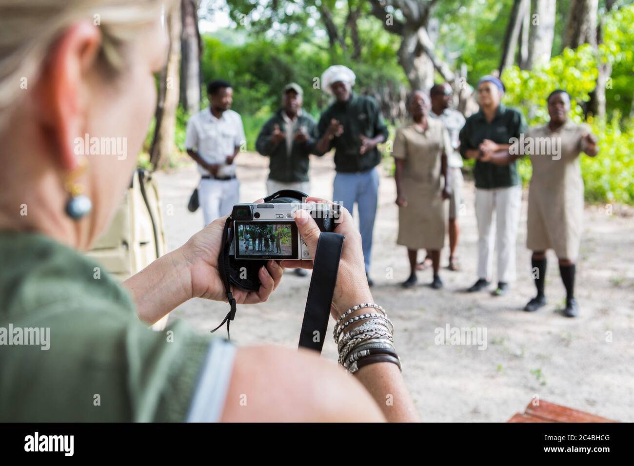 adult woman taking pictures of tented camp staff, Botswana Stock Photo
