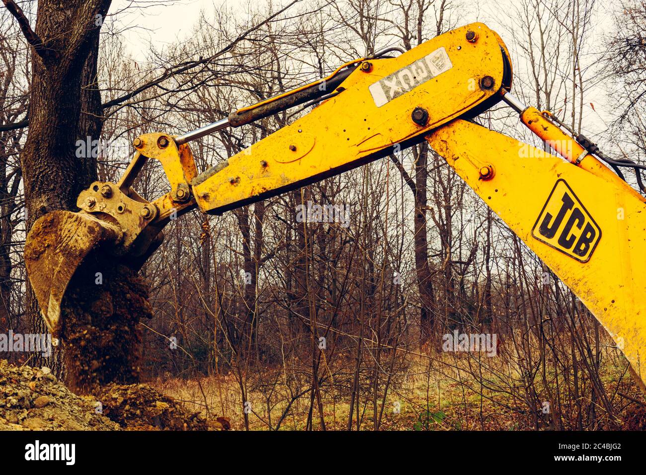 Trostyanets, Ukraine December 20, 2019: excavator digs soil in pond forest.2020 Stock Photo