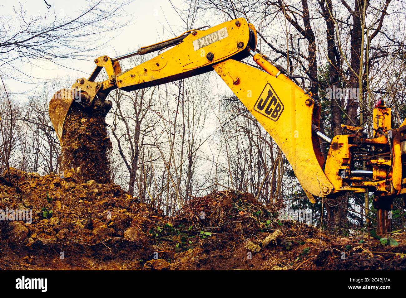 Trostyanets, Ukraine December 20, 2019: excavator digs soil in pond forest.2020 Stock Photo