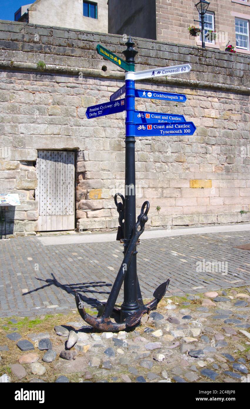 Signpost at Quay Walls, Berwick-upon-Tweed, Northumberland, UK, with two anchors at the base, Stock Photo