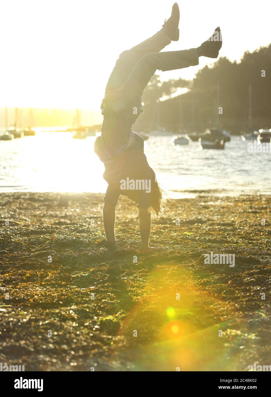 handstand at the shore naked man doing a handstand Stock Photo - Alamy