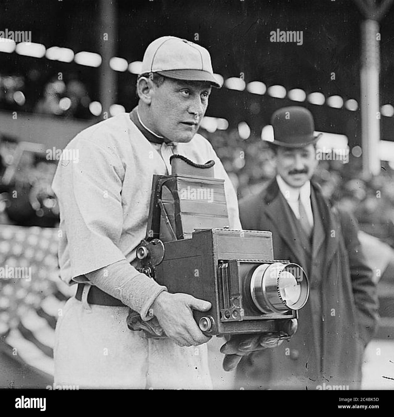 TELEPHOTO LENS An American baseball player tries his hand at photography about 1930 Stock Photo