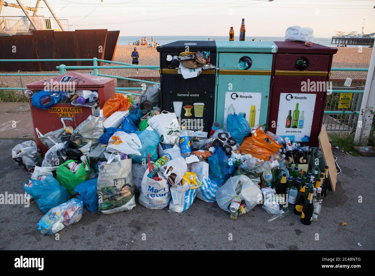 Recycling bins on Brighton seafront overflowing with rubbish and waste